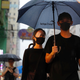 A demonstrator wears an eye patch to show solidarity with a woman injured in her eye by a beanbag during a previous protest as she marches along a street in Hong Kong, Sunday, Aug. 18, 2019.